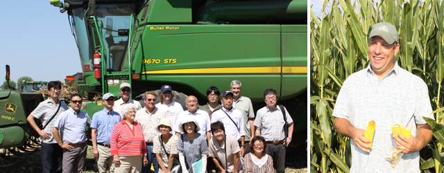 A corn harvester and the delegation (left), Mr. John Caplin, a corn grower